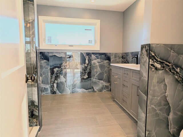 1135 Logan Rd, Wantagh, NY 11793 - bathroom featuring vanity, walk in shower, and tile walls