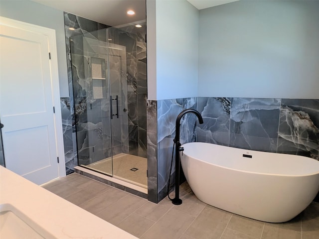 1135 Logan Rd, Wantagh, NY 11793 - full bath with tile walls, a soaking tub, a marble finish shower, recessed lighting, and a wainscoted wall