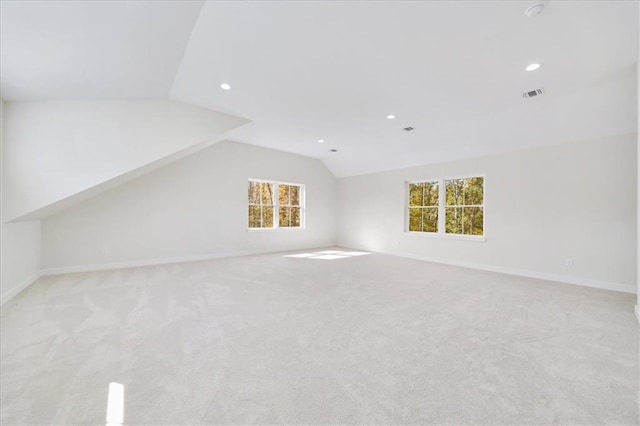 additional living space featuring visible vents, baseboards, carpet, recessed lighting, and vaulted ceiling