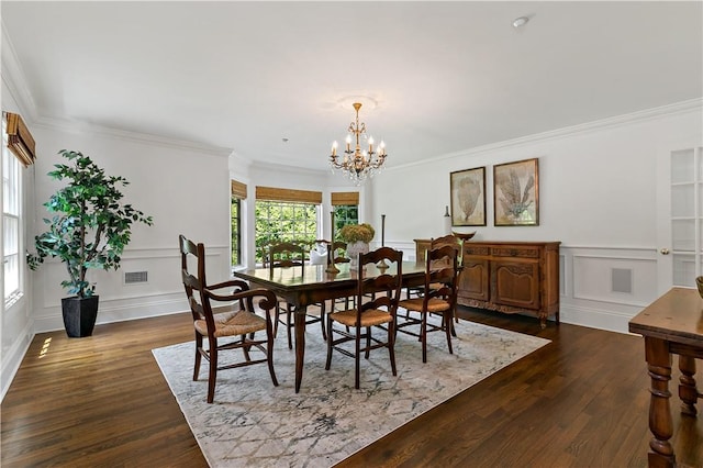 70 Haights Cross Rd, Chappaqua, NY 10514 - dining room with a decorative wall, a chandelier, dark wood-type flooring, crown molding, and wainscoting