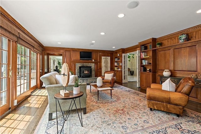 70 Haights Cross Rd, Chappaqua, NY 10514 - living room featuring crown molding, wood finished floors, wooden walls, recessed lighting, and a fireplace