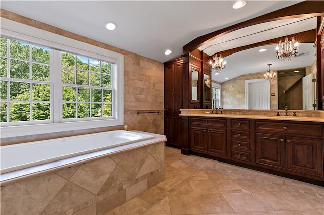 70 Haights Cross Rd, Chappaqua, NY 10514 - bathroom featuring a chandelier, lofted ceiling, a bath, tile patterned floors, and double vanity