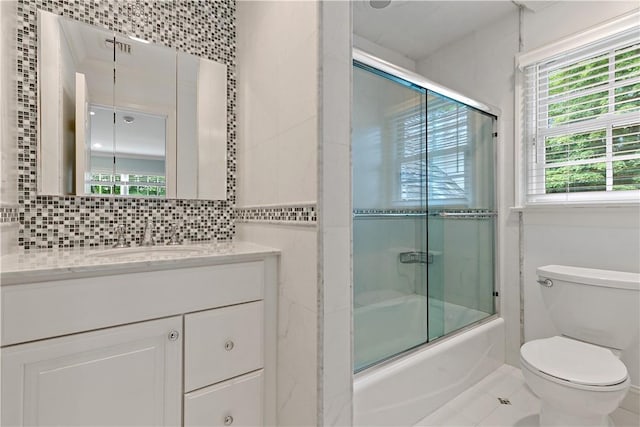 70 Haights Cross Rd, Chappaqua, NY 10514 - bathroom featuring toilet, shower / bath combination with glass door, vanity, tile patterned flooring, and tasteful backsplash