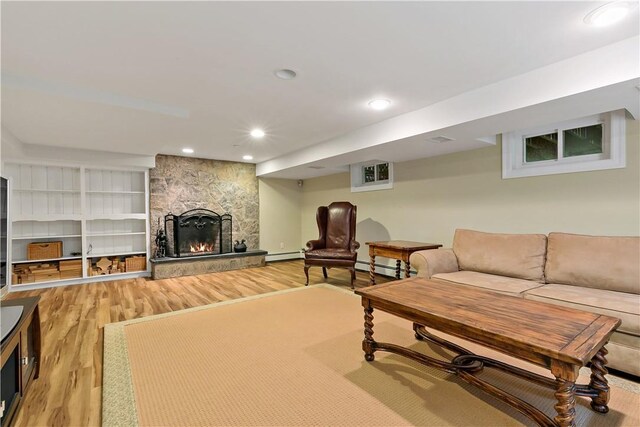 70 Haights Cross Rd, Chappaqua, NY 10514 - living area featuring light wood-style floors, a stone fireplace, a baseboard radiator, recessed lighting, and baseboard heating