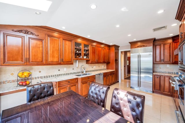 34 Duke Dr, Manhasset Hills, NY 11040 - kitchen featuring stainless steel appliances, visible vents, a sink, a skylight, and tasteful backsplash