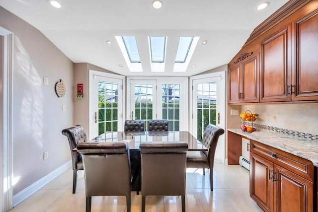 34 Duke Dr, Manhasset Hills, NY 11040 - dining room featuring a baseboard radiator, vaulted ceiling with skylight, light tile patterned flooring, baseboards, and recessed lighting