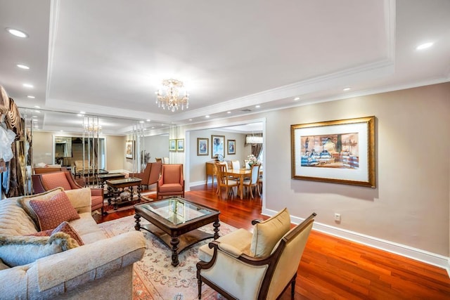 34 Duke Dr, Manhasset Hills, NY 11040 - living room featuring a tray ceiling, hardwood / wood-style floors, baseboards, and an inviting chandelier
