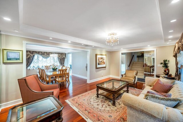 34 Duke Dr, Manhasset Hills, NY 11040 - living area with wood finished floors, ornamental molding, a chandelier, and a tray ceiling
