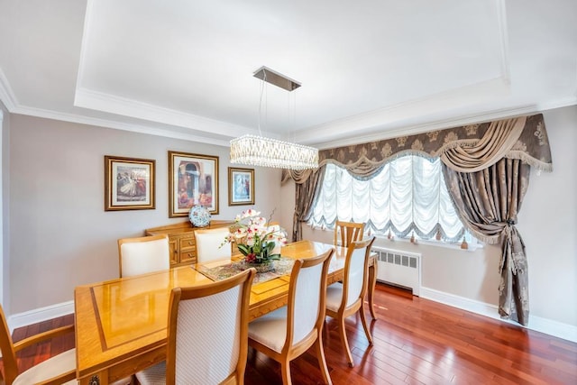 34 Duke Dr, Manhasset Hills, NY 11040 - dining area with a raised ceiling, baseboards, radiator heating unit, hardwood / wood-style floors, and ornamental molding