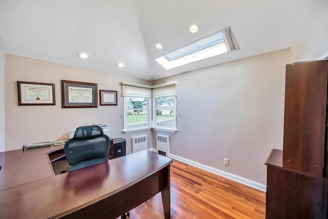 34 Duke Dr, Manhasset Hills, NY 11040 - office area with radiator, wood finished floors, a skylight, and recessed lighting