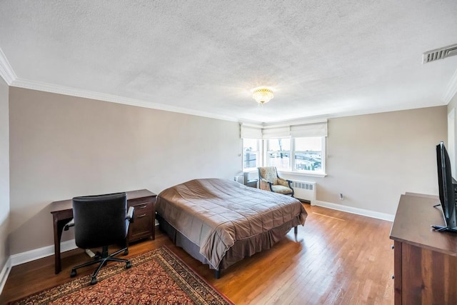 34 Duke Dr, Manhasset Hills, NY 11040 - bedroom with radiator heating unit, visible vents, a textured ceiling, and crown molding