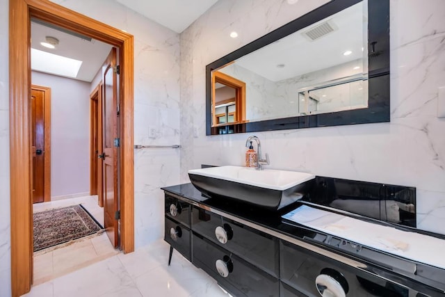 34 Duke Dr, Manhasset Hills, NY 11040 - bathroom with a marble finish shower, visible vents, a skylight, marble finish floor, and vanity