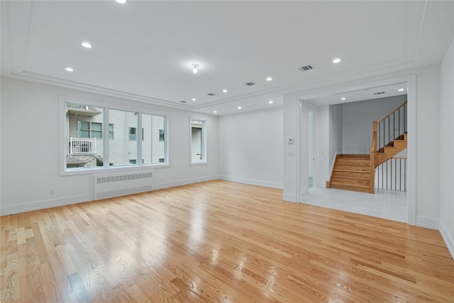 5 Francis Pl Unit 214, Monsey, NY 10952 - spare room featuring radiator, light wood-style flooring, stairway, and recessed lighting