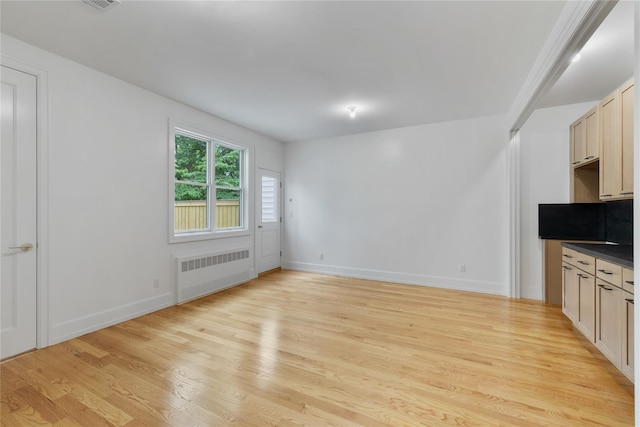 5 Francis Pl Unit 214, Monsey, NY 10952 - unfurnished living room featuring radiator heating unit and light wood finished floors