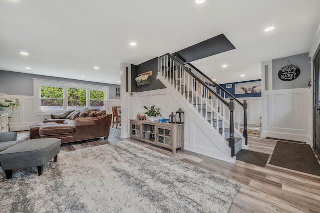 6 Premier Ct, Port Jefferson Station, NY 11776 - living area featuring a decorative wall, wood finished floors, recessed lighting, and stairway