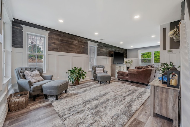 6 Premier Ct, Port Jefferson Station, NY 11776 - living area with light wood-style floors, a decorative wall, a wainscoted wall, and recessed lighting