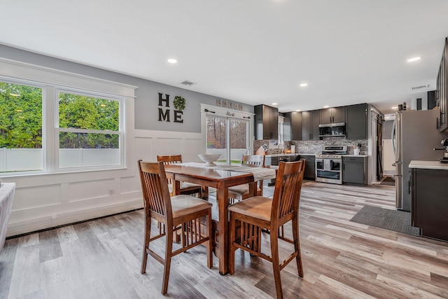 6 Premier Ct, Port Jefferson Station, NY 11776 - dining area featuring recessed lighting, a decorative wall, light wood finished floors, and visible vents