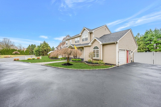 6 Premier Ct, Port Jefferson Station, NY 11776 - view of front of home with an attached garage, fence, a front lawn, and aphalt driveway