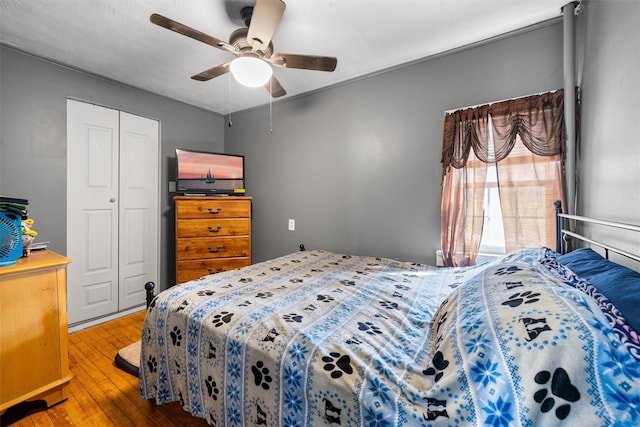 bedroom with a closet, ceiling fan, and wood-type flooring