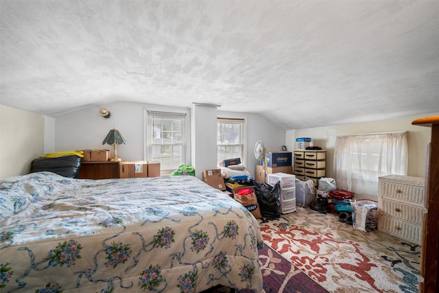 carpeted bedroom featuring a textured ceiling and vaulted ceiling