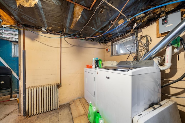 laundry room featuring laundry area, washing machine and clothes dryer, and radiator