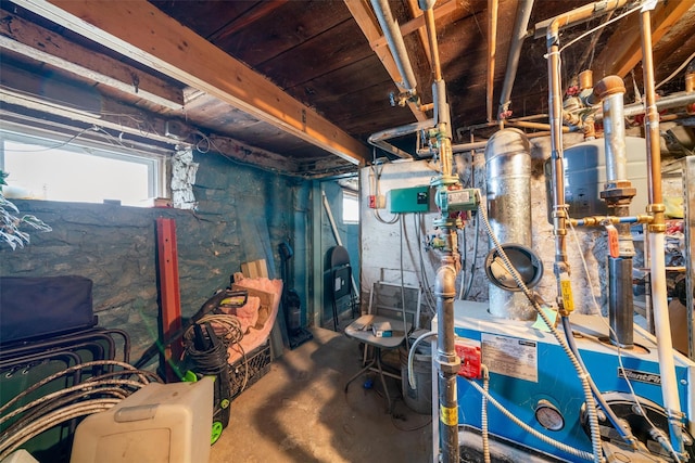 below grade area with a heating unit and a wealth of natural light
