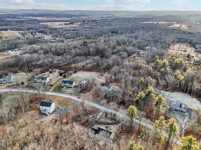 birds eye view of property with a wooded view
