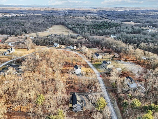 drone / aerial view featuring a wooded view