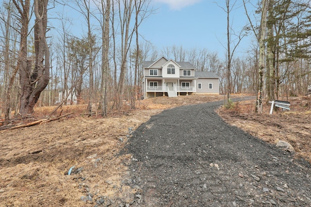 traditional-style house with gravel driveway and covered porch