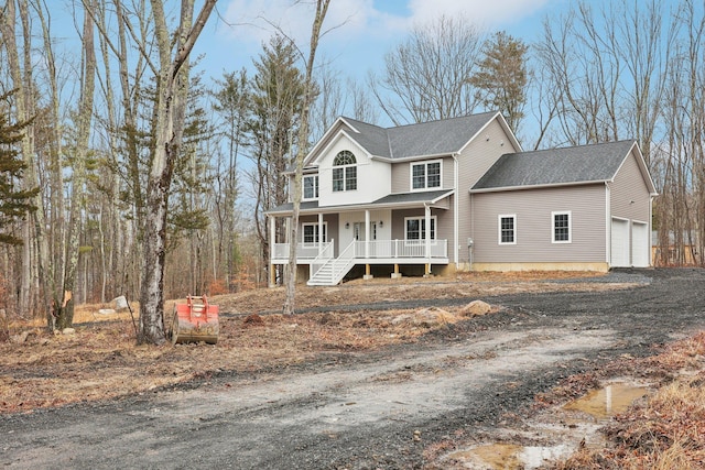 view of front facade featuring covered porch, driveway, and roof with shingles