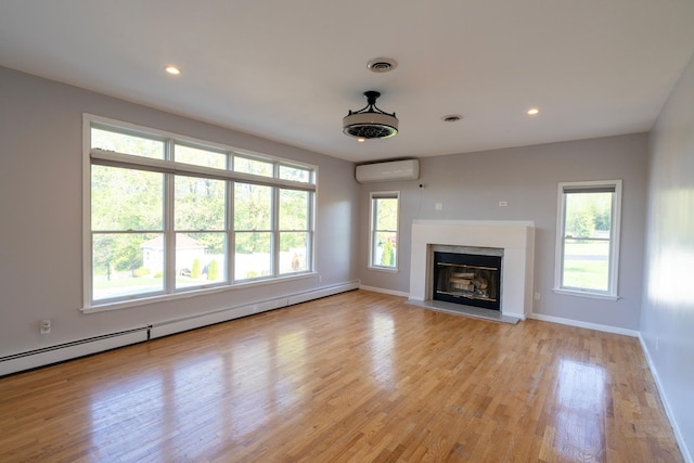 107 Denniston Dr, New Windsor, NY 12553 - unfurnished living room featuring an AC wall unit, plenty of natural light, baseboards, and recessed lighting