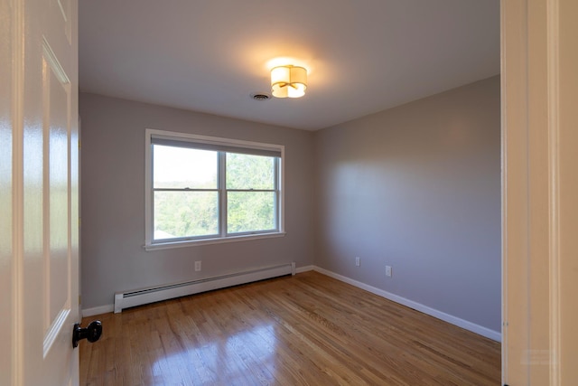 107 Denniston Dr, New Windsor, NY 12553 - unfurnished room with a baseboard heating unit, wood finished floors, and baseboards