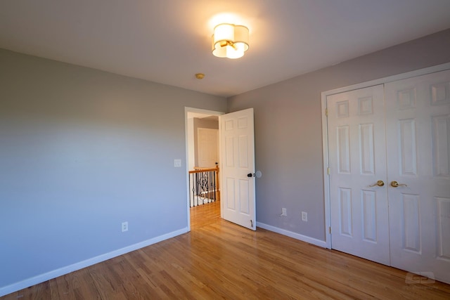 107 Denniston Dr, New Windsor, NY 12553 - unfurnished bedroom with baseboards, wood finished floors, and a closet