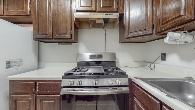 111-09 62nd Dr, Forest Hills, NY 11375 - kitchen featuring light countertops, stainless steel gas range, freestanding refrigerator, and under cabinet range hood