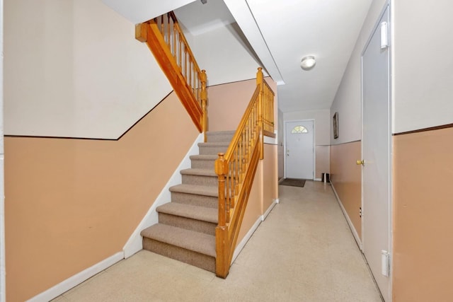 staircase with tile patterned floors and baseboards