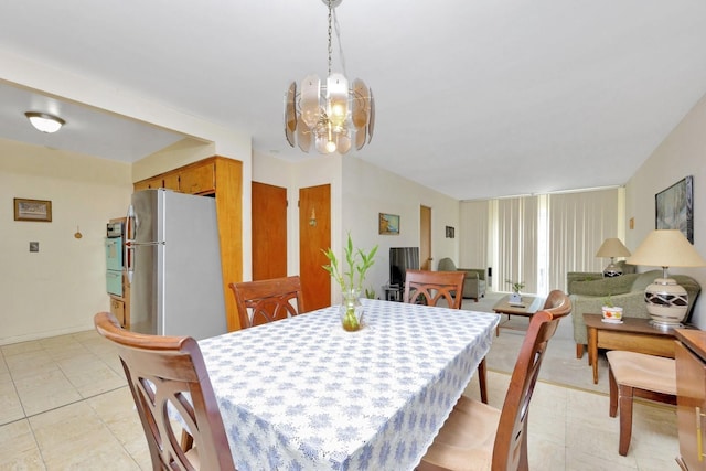 dining room with light tile patterned floors, baseboards, and a chandelier
