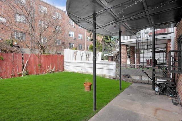 view of property's community with fence private yard and a lawn