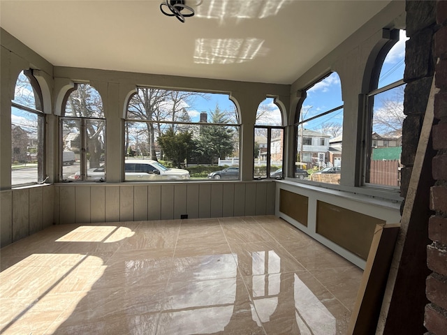 unfurnished sunroom with a wealth of natural light