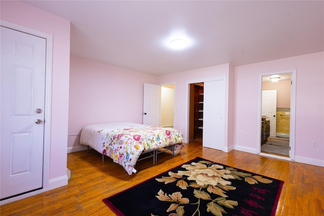 168 Vails Gate Heights Dr, New Windsor, NY 12553 - bedroom with ensuite bath, baseboards, and wood-type flooring