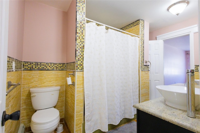 168 Vails Gate Heights Dr, New Windsor, NY 12553 - bathroom with vanity, tile walls, a shower with curtain, a wainscoted wall, and toilet