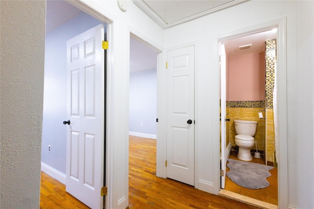 168 Vails Gate Heights Dr, New Windsor, NY 12553 - hall with visible vents, attic access, wood finished floors, and tile walls