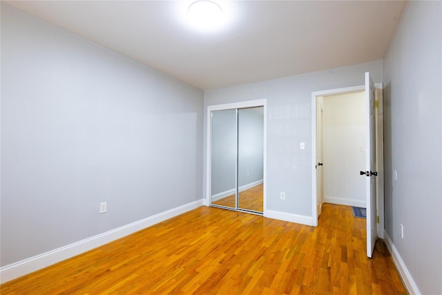 168 Vails Gate Heights Dr, New Windsor, NY 12553 - unfurnished bedroom with baseboards, light wood finished floors, and a closet