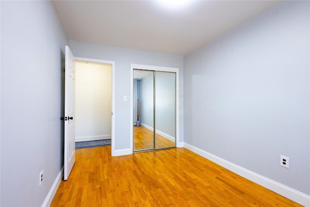 168 Vails Gate Heights Dr, New Windsor, NY 12553 - unfurnished bedroom featuring light wood-style flooring, a closet, and baseboards
