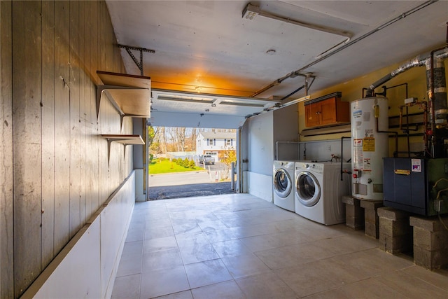 168 Vails Gate Heights Dr, New Windsor, NY 12553 - clothes washing area featuring wooden walls, washer and dryer, gas water heater, a heating unit, and a garage