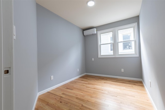 5933 48th Ave, Woodside, NY 11377 - spare room featuring light wood-style floors, a wall mounted AC, and baseboards