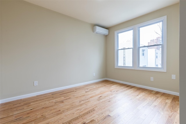 5933 48th Ave, Woodside, NY 11377 - spare room featuring light wood-style floors, baseboards, and an AC wall unit
