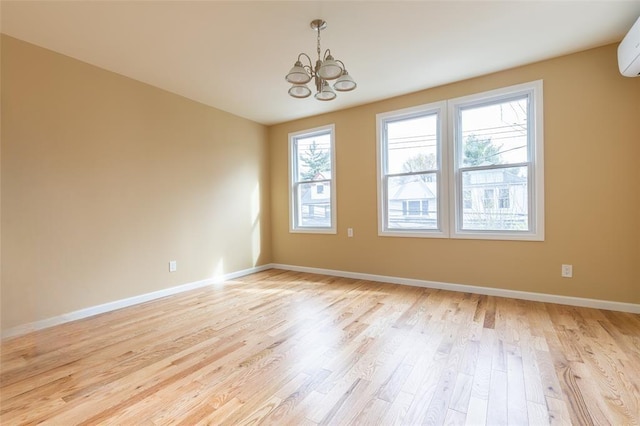 5933 48th Ave, Woodside, NY 11377 - empty room with light wood finished floors, baseboards, an inviting chandelier, and an AC wall unit