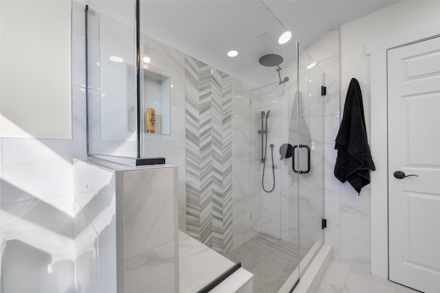 bathroom featuring a shower stall and marble finish floor