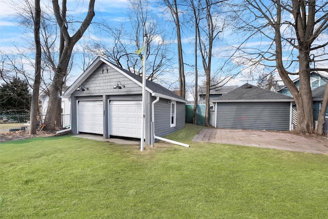 detached garage featuring fence