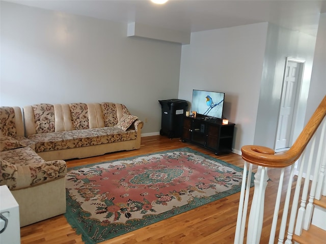 living area featuring baseboards and wood finished floors